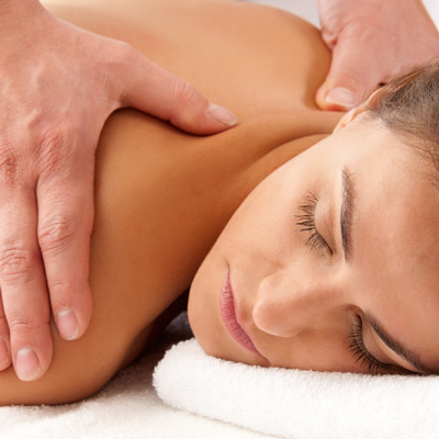 A woman receiving a back massage at AcuDenver.